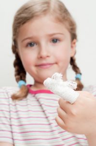 First Aid - little girl with bandage on finger